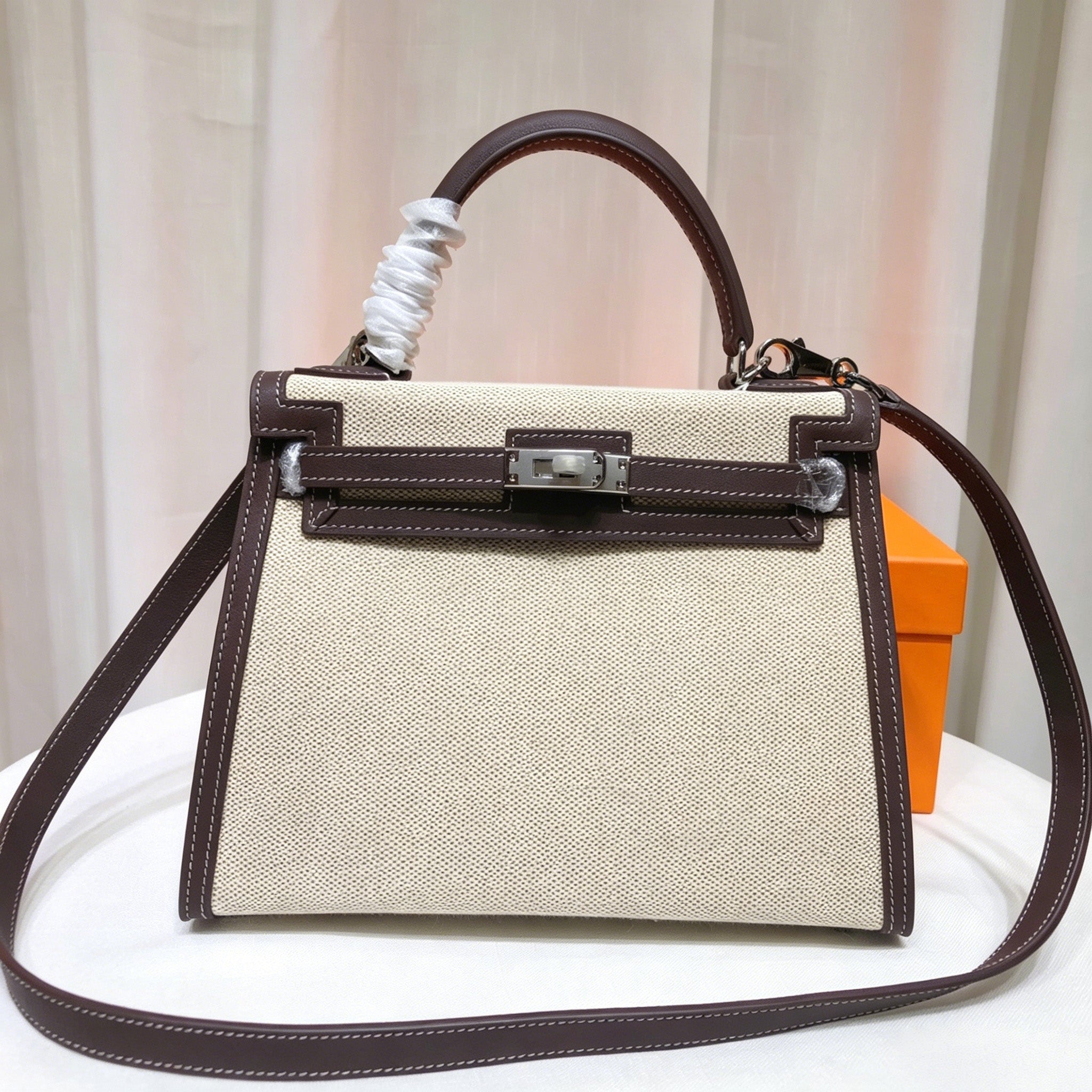 Kelly 25 Bag With Exterior Stitching Crafted Of Patchwork Canvas & Premium Swift Leather, Classic Deep Ebony Wood Shade, Unique Mixed Material Texture With Distinct Vintage Charm Dimensions: Length 25 * Width 10 * Height 18cm